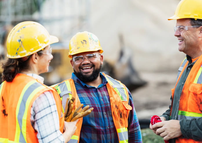construction workers taking a break, chatting and smiling