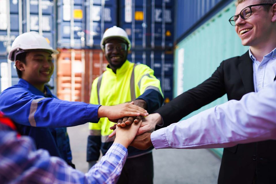 Employees with hand in the middle together